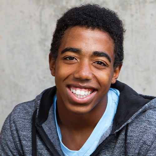 Young man with brighter smile after teeth whitening