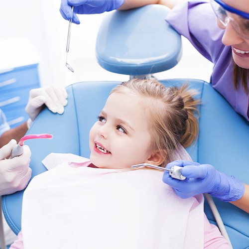 Little girl in dental chair during tooth extraction