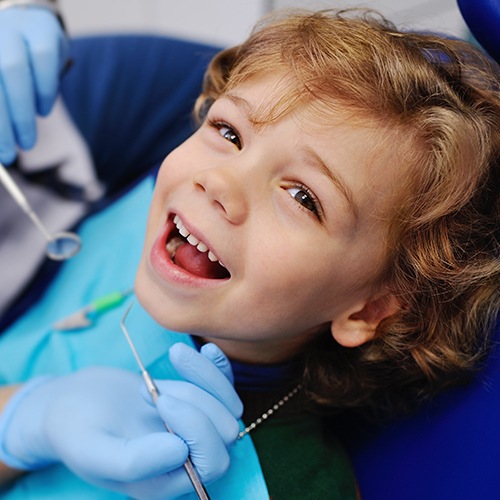 Little boy smiling after tooth extraction