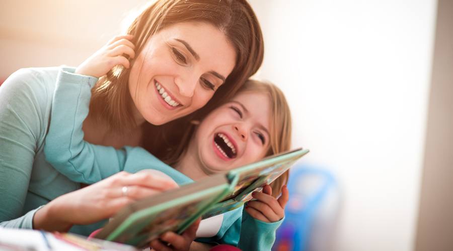 Mother and daughter laughing together after visiting the pediatric dentist