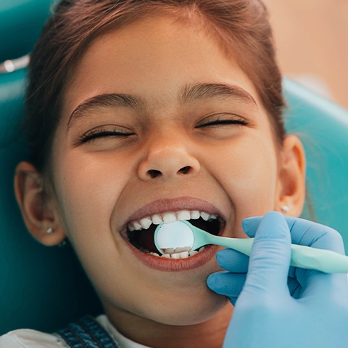 Child laughing during dental exam