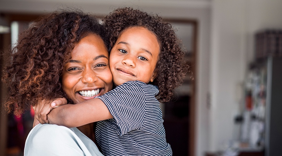 Mother and daughter smiling together at pediatric preventive dentistry visit