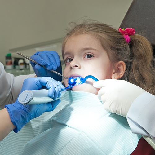 Child receiving dental sealants