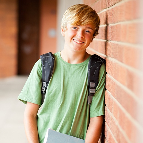 Young boy with healthy smile after metal free dental crown restoration