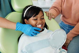 Patient smiling after receiving dental sealants during an appointment