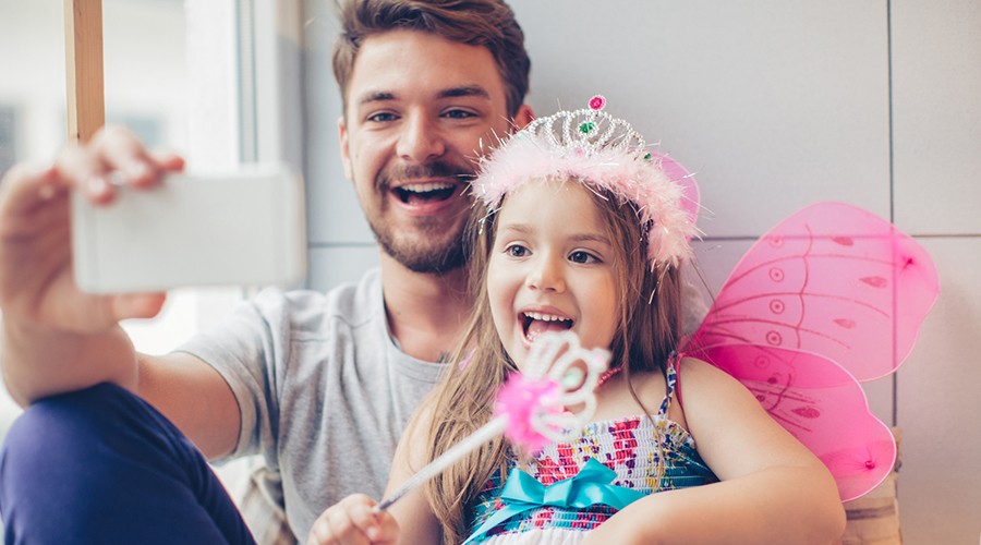 Happy father and daughter taking picture together after sedation dentistry visit