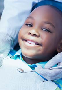 Little girl and mom smiling during preventive dentistry checkup