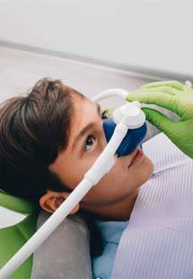 Young boy in dental chair with nitrous oxide sedation dentistry mask