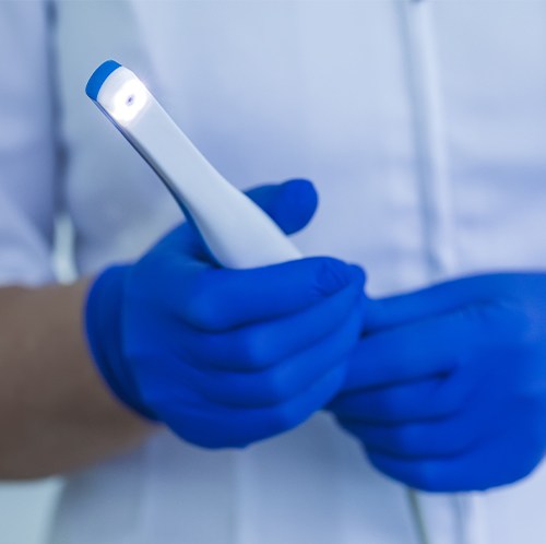 Dental team member holding intraoral camera