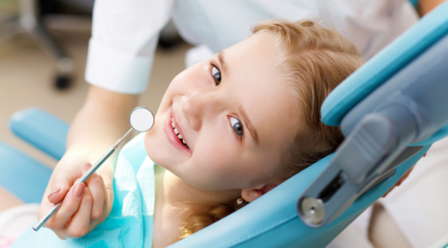 Little girl smiling after receiving tooth-colored fillings in Levittown 