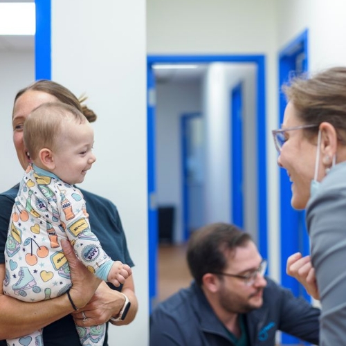 Smiling baby with new teeth after her dentist for infants visit