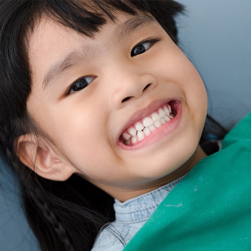 Young child showing teeth after dentistry for children