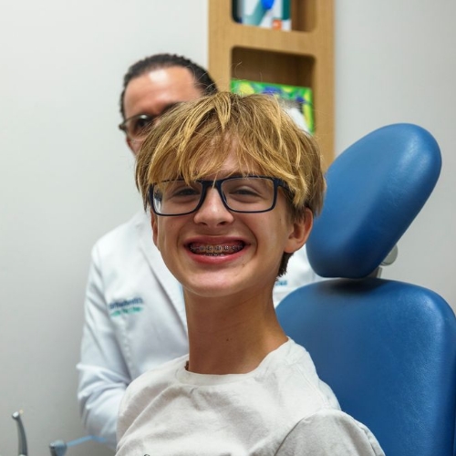 Young woman smiling after receiving dentistry for teens