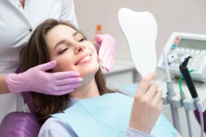 Patient looking into mirror at dentist's office. 